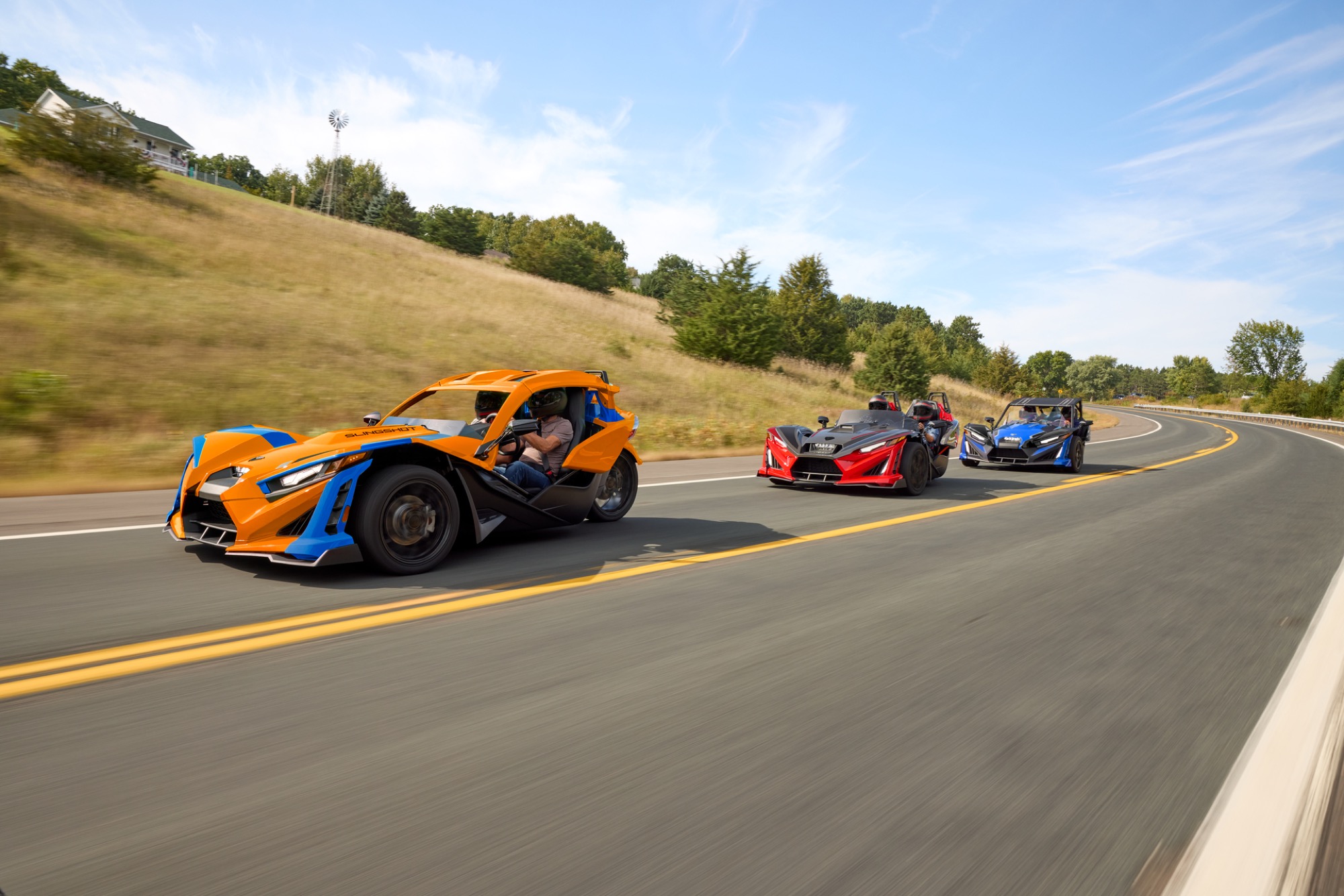 Three Polaris Slingshots driving together
